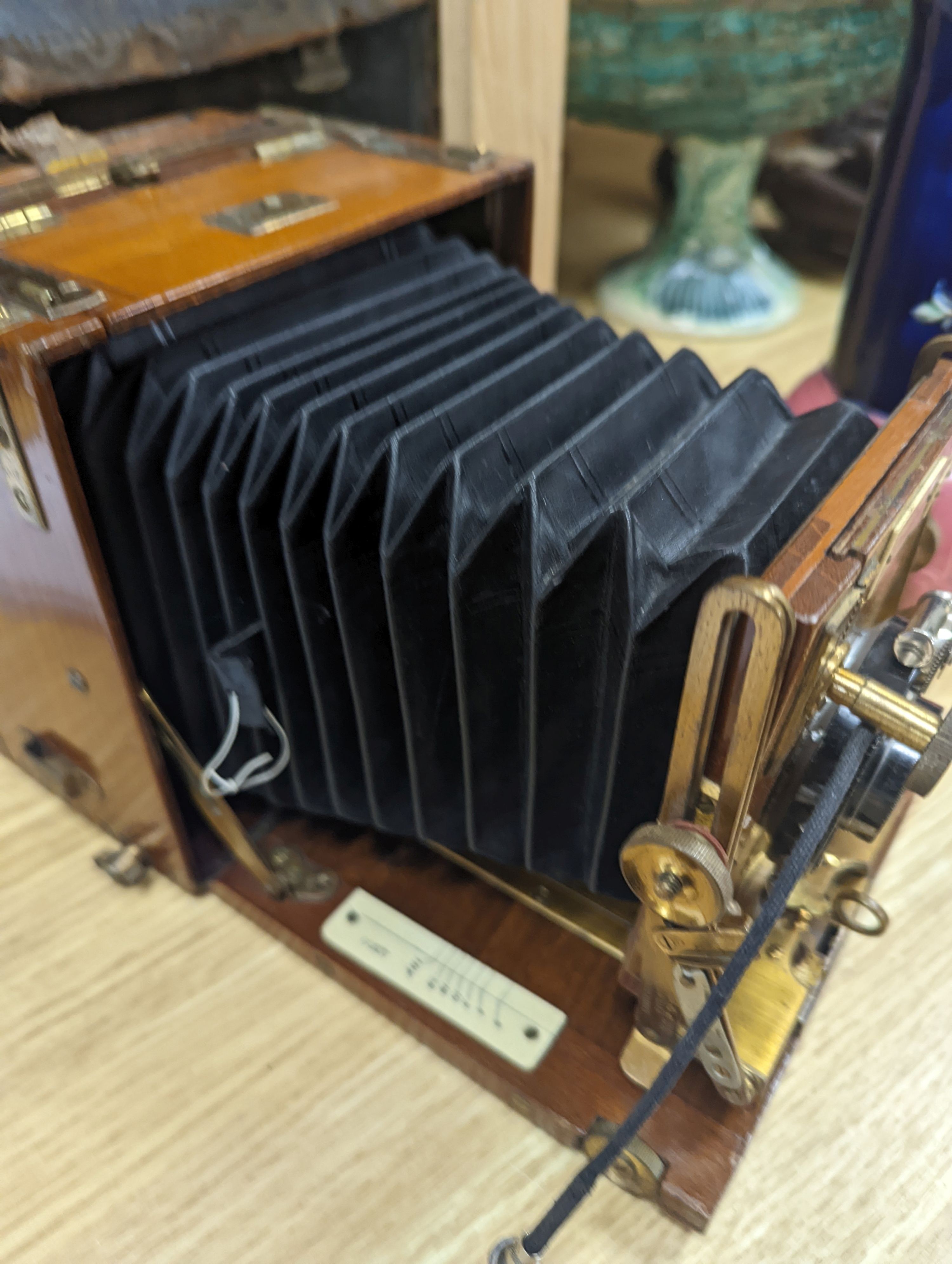 A Sanderson ‘Tropical Model’ plate camera, leather cased with various mahogany plate holders.